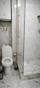 a bathroom with a toilet and a shower at Amanat residence in Osh