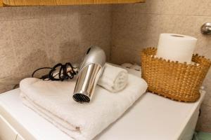 a hair dryer sitting on top of a bathroom sink at Casa Chechi tra Aprica e Ponte di Legno in Monno