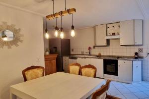 a kitchen with a table and chairs in it at PERLE RARE in Metz
