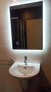 a white sink in a bathroom with a mirror at Flat 1 Central Apartment in Swieqi in Is-Swieqi