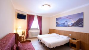 Postel nebo postele na pokoji v ubytování Albergo Ristoro Sitten - 2300 mt