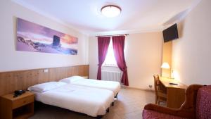 Postel nebo postele na pokoji v ubytování Albergo Ristoro Sitten - 2300 mt