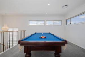 a pool table in the middle of a room at Shoreline Luxe - Refined Beachside Elegance with Spa in Caves Beach