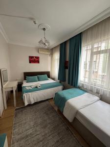 a bedroom with two beds with blue and white at BACHOS HOTEL SULTANAHMET sea view terrace in Istanbul