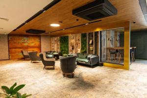 a living room with couches and chairs at MM Boutique Hotel in Burgas