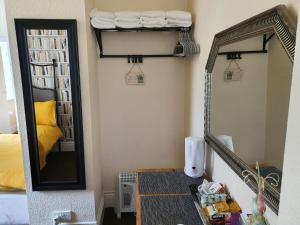 a mirror and a table in a room with a bed at Windsor House Hotel in Blackpool