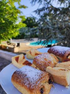 a plate of pastries and bread on a table at Villa Apollonia B&B in Monopoli