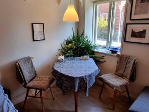 a dining room with a table and two chairs at Guesthouse Grønnegade in Stubbekøbing +41 photos