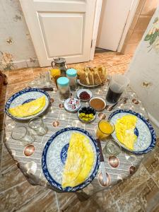 a table with three plates of eggs on it at Surf and Stay Anza - Surf Territory in Agadir