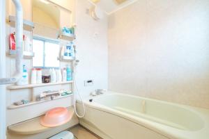 a bathroom with a bath tub and a sink at 魚沼ヒミツ基地 in Uonuma +37 photos