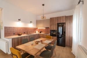 a kitchen and dining room with a wooden table and chairs at Sylvia's Pramanta Villas in Pramanta
