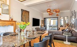 a living room with a table and a couch at Luxe city villa te Hasselt in Hasselt