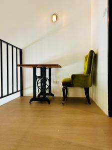 a table and a green chair in a room at Island House Rentals 46 in Ko Samed +24 photos