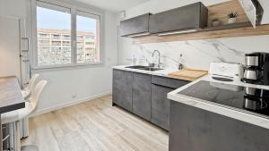 a kitchen with a sink and a counter top at Appartement a quelques minutes à pieds des plages in Fréjus +21 photos