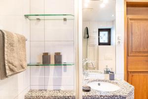 a bathroom with a sink and a shower at Ferienhaus Frühholz - Fewo Alpspitz in Grainau +18 photos