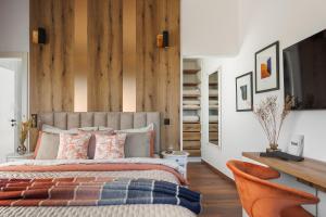 a bedroom with a bed and a desk and chairs at Villa Luxor in Zambratija +30 photos