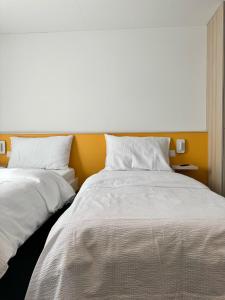 Postel nebo postele na pokoji v ubytování N's Hotel - Self-Check-in Hotel