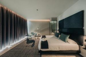 a bedroom with a bed and a desk in a room at MUUN Landscape Hotel in Las Alboredas