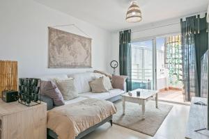 a living room with a couch and a table at Apartamento Cubelles Molí Baix in Cubelles +16 photos