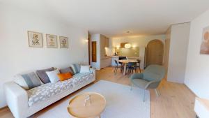 a living room with a couch and a table at Leonard in Celerina