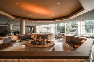a lobby with couches and tables in a building at Ruissalo Spa Hotel in Turku