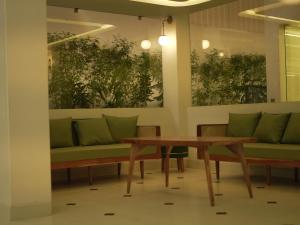 a dining room with benches and a table at The Lavish Stay in Varanasi