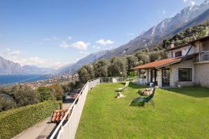 a balcony of a house with a view of the mountains at Villa Manuela-Vista Lago in Brenzone sul Garda