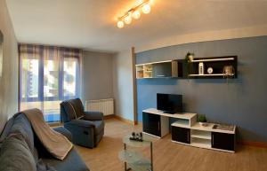 a living room with a couch and a tv at Apartamento Oteixon in Narvarte