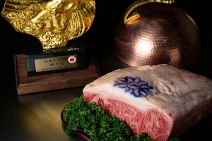 a cake sitting on a table next to a trophy at The Prince Park Tower Tokyo - Preferred Hotels & Resorts, LVX Collection in Tokyo