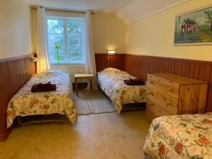 a hotel room with two beds and a window at Skagagården-peaceful stay near Tiveden National Park in Undenäs