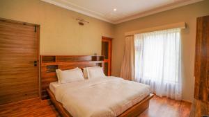 a bedroom with a large bed and a window at Richi A Boutique House in Leh