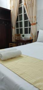 Postel nebo postele na pokoji v ubytování Mango Garden Hoi An Homestay