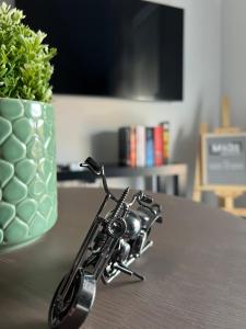 a remote control on a table next to a vase at Madi apartment in Veria