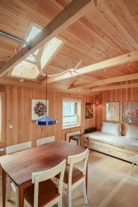 a dining room with a table and a couch at Central Tórshavn Stay in the Charming Old Town in Tórshavn