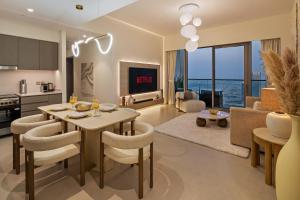 a kitchen and living room with a table and chairs at Bella Elite Homes at Grande Signature Full Burj Khalifa and Foutain View - Brand New Luxury Apartment in Dubai