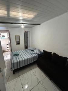 En eller flere senge i et værelse på Arraial suíte