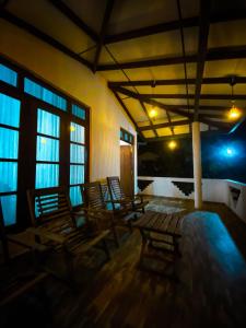 a group of chairs in a room with windows at Home Guard Villa in Kamburugamuwa +14 photos