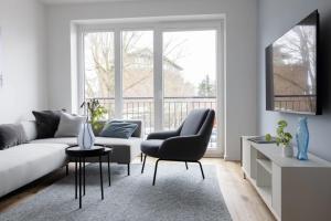 a living room with a couch and a chair at Mole in Sankt Peter-Ording