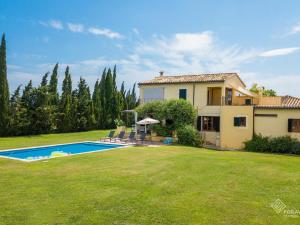 a villa with a swimming pool in a yard at Son Senyor in Sa Pobla