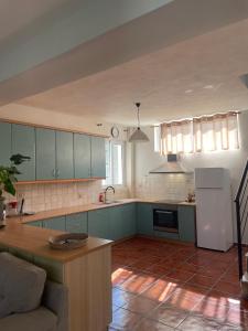 a kitchen with blue cabinets and a counter top at Sakuras House in Pesádha +4 photos