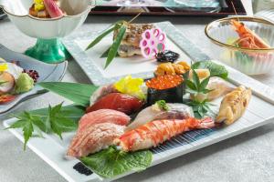 a plate of sushi and seafood on a table at The Prince Park Tower Tokyo - Preferred Hotels & Resorts, LVX Collection in Tokyo
