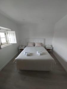 En eller flere senge i et værelse på Casa da Biquinha