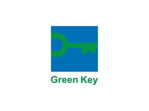 a close up of a green key logo at ibis budget Issy Les Moulineaux Paris Ouest in Issy-les-Moulineaux