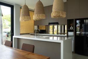 a kitchen with a sink and two baskets at Newly Constructed Villa with Panoramic Views, Huge Pool, and 4 Spacious Bedrooms! in Canggu +6 photos