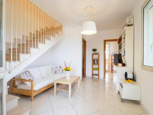 a living room with a white couch and stairs at Villa Mirò - Escape to Salento in Melendugno