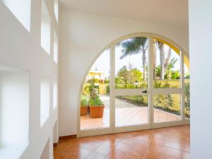 an arched glass door in a house with a patio at Villa Mirò - Escape to Salento in Melendugno