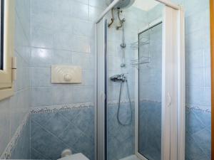 a bathroom with a shower with a glass door at Villa Mirò - Escape to Salento in Melendugno +18 photos