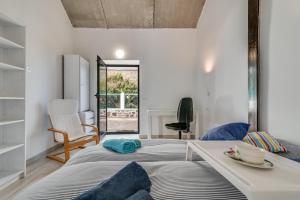 a bedroom with a large bed and a table at Home2Book Mountain Serenity House Agaete, Terrace in Agaete