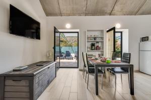 a kitchen and dining room with a table and chairs at Home2Book Mountain Serenity House Agaete, Terrace in Agaete