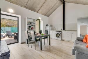 a kitchen and living room with a table and chairs at Home2Book Mountain Serenity House Agaete, Terrace in Agaete